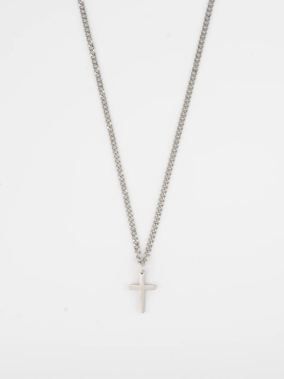 Close-up of the MERE stainless steel cross pendant